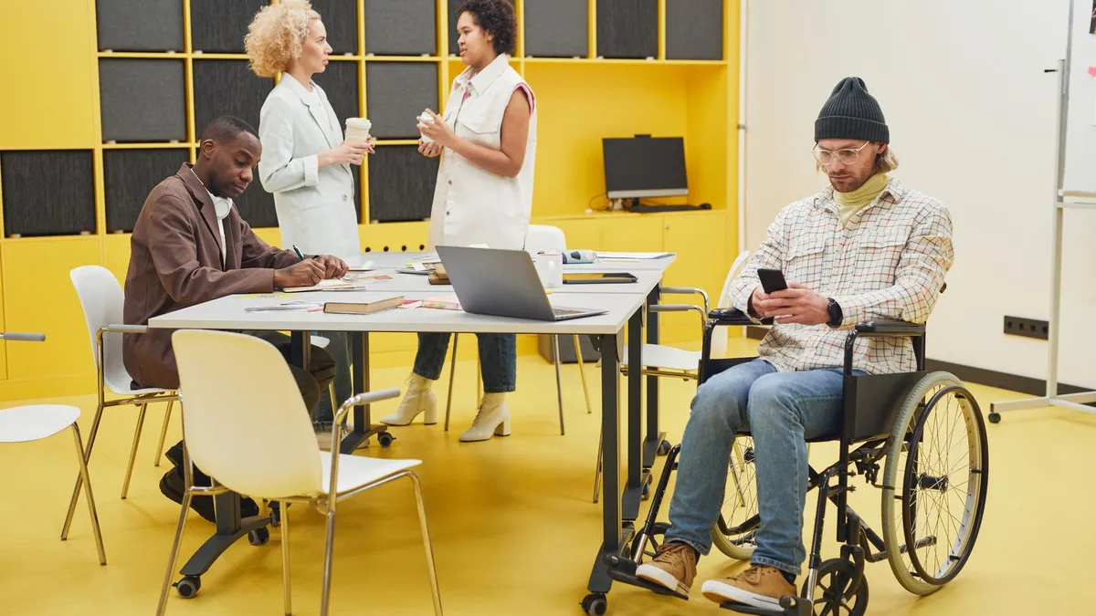 A diverse office team collaborating indoors, showcasing teamwork and inclusivity.