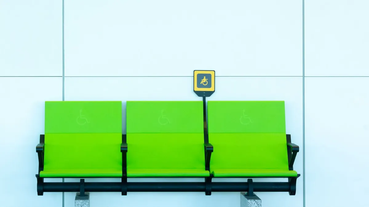 Vibrant green seats with handicap signs against a minimalist background.