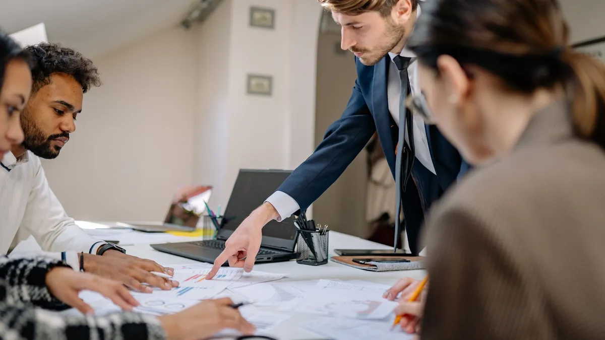 A diverse team engaged in a business meeting, fostering collaboration and teamwork in an office setting.