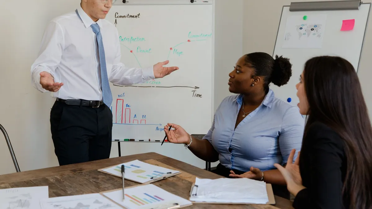 A diverse team discussing business strategies during a meeting with charts.