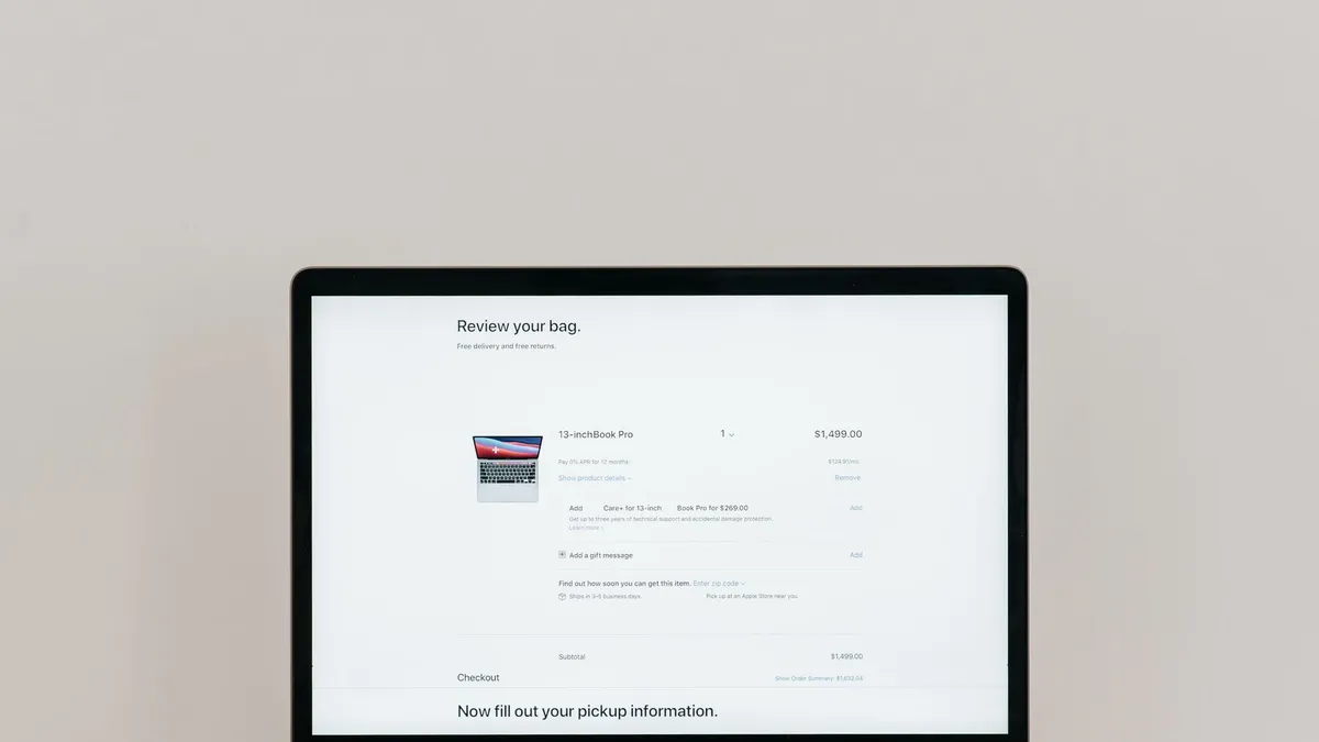 Minimalist laptop showing an online checkout screen on a white background, ideal for tech context.