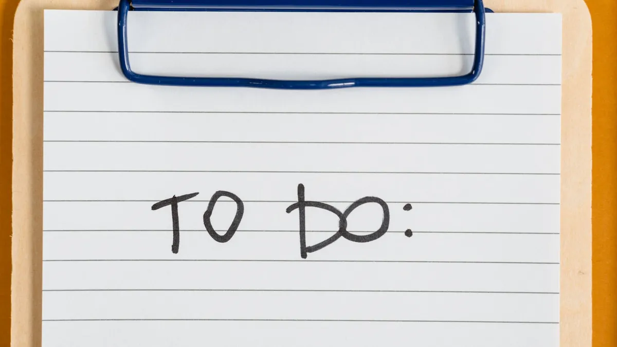 Clean and simple image of a to-do list on a clipboard with lined paper.