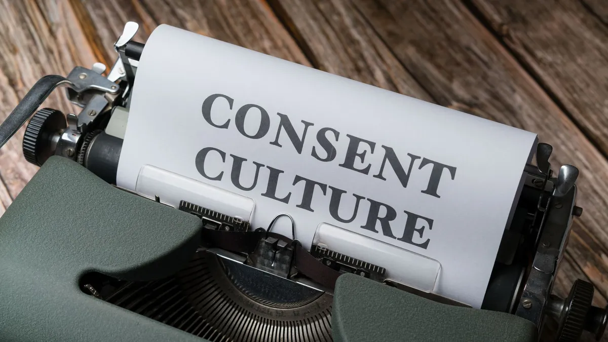 Close-up of a typewriter with paper showing 'Consent Culture' in a vintage aesthetic.