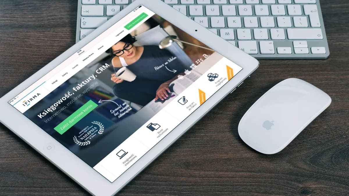 A tablet with a financial website open, alongside a white keyboard and mouse. Ideal for tech-theme stock images.