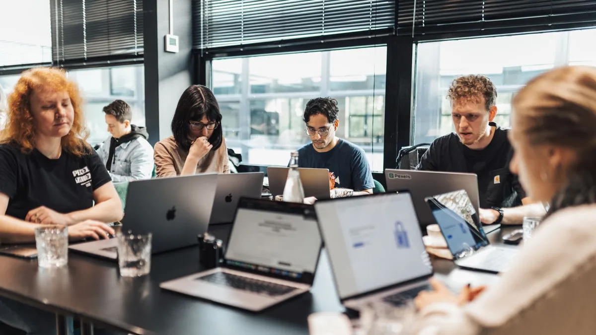 Focused team engaged in discussion and planning at a modern office setting.