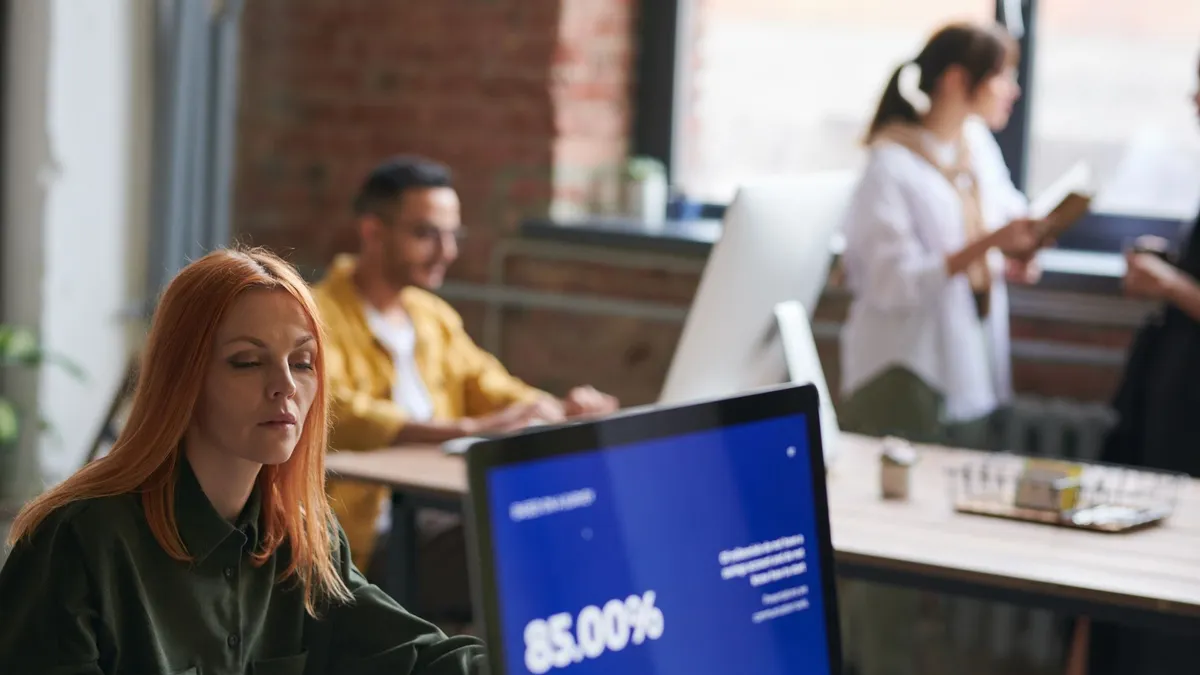 Professionals working in a stylish coworking space, focusing on growth and collaboration.