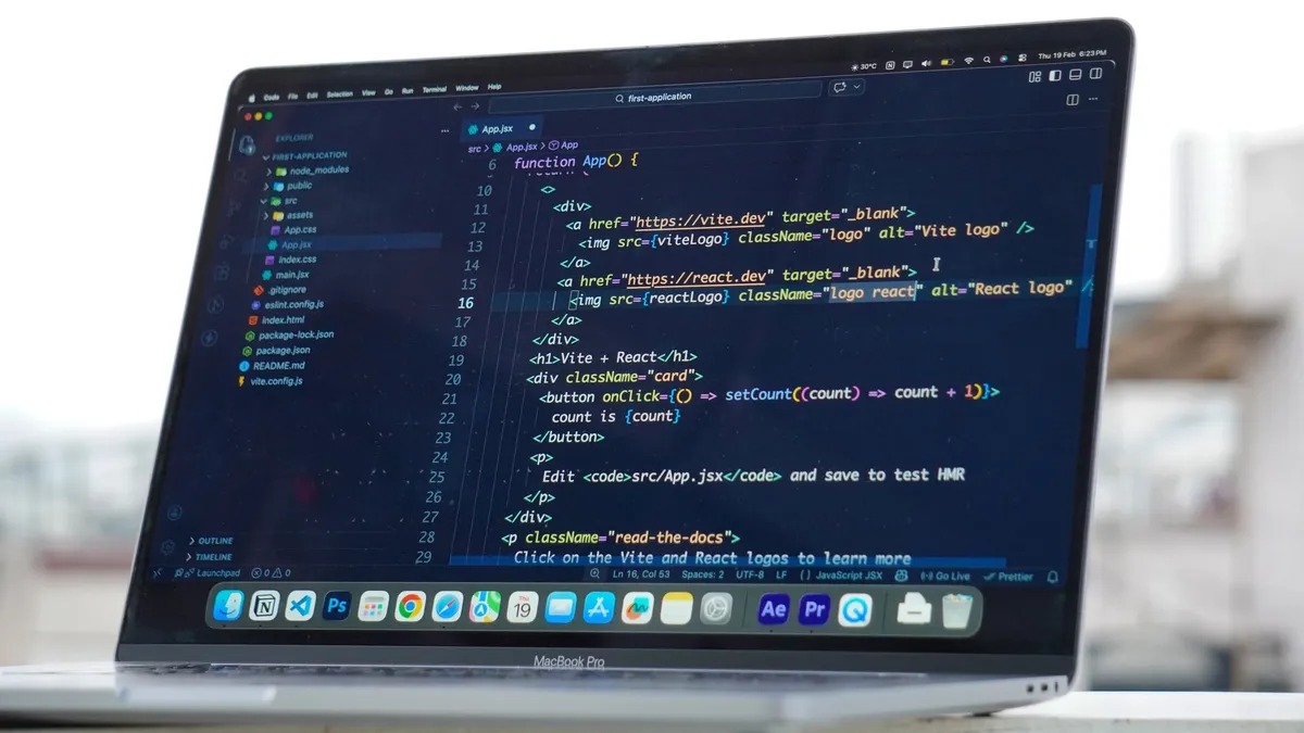 Coding on a laptop outdoors, showcasing a rooftop urban lifestyle in Surat, India.
