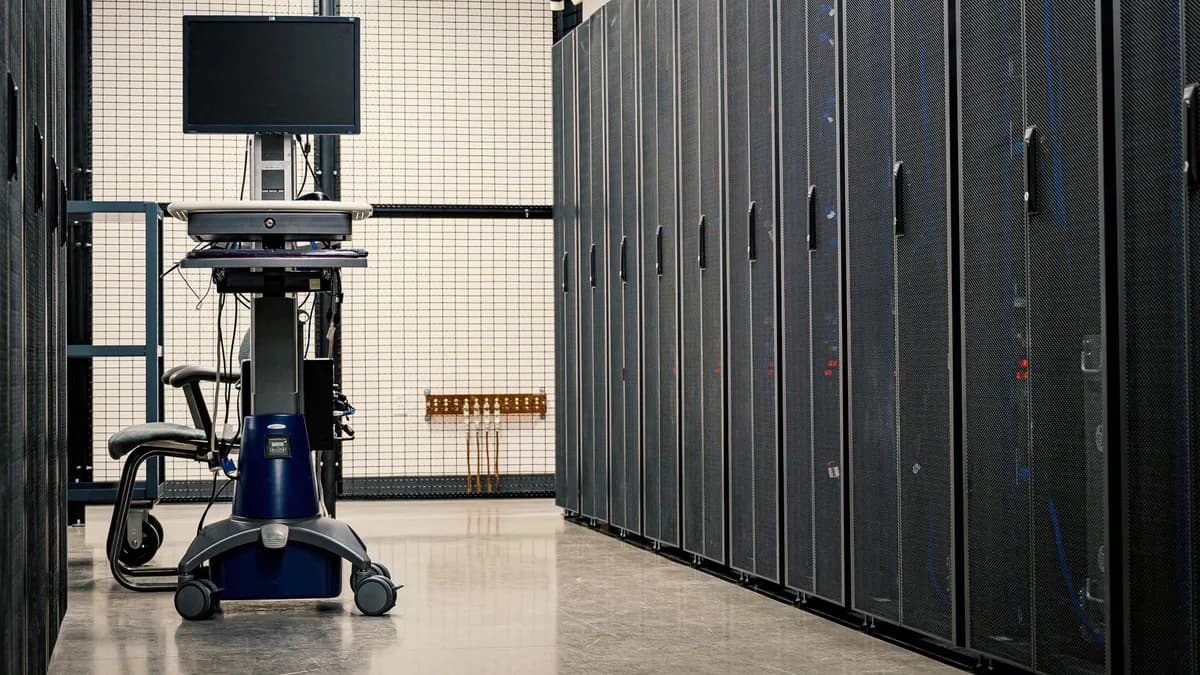 Contemporary computer on support between telecommunication racks and cabinets in modern data center