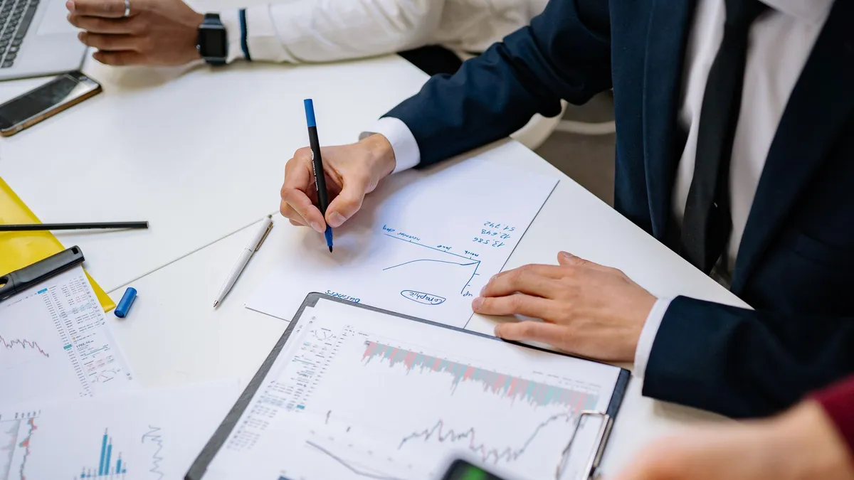 Professionals analyzing financial charts in a corporate setting.