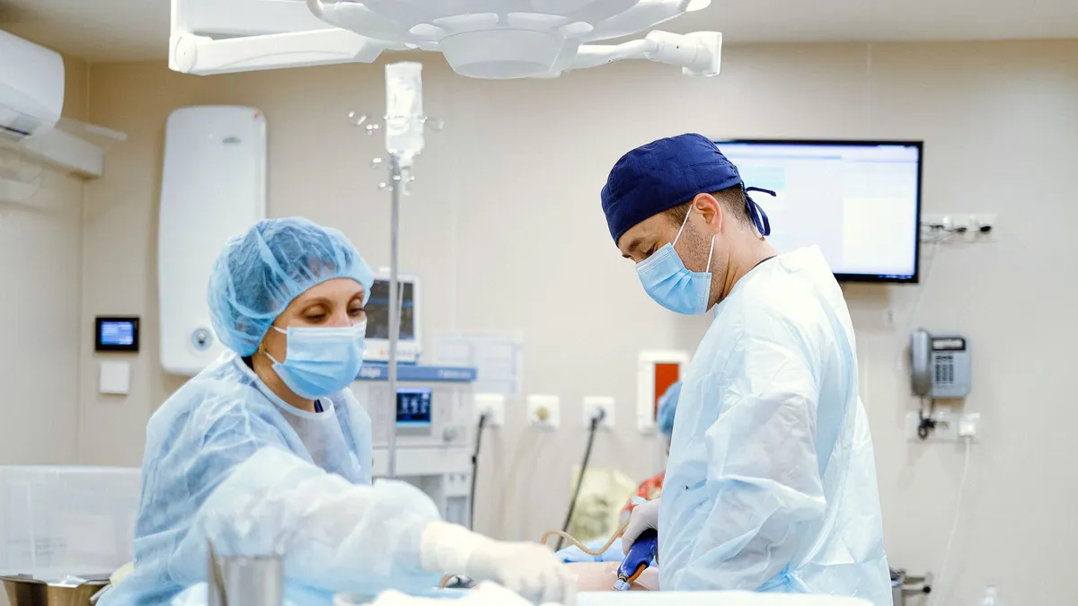 Team of doctors and nurses in an operating room performing surgery with focus and precision.