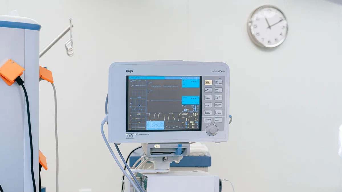 A modern heart rate monitor in a sterile hospital setting, showcasing medical technology.