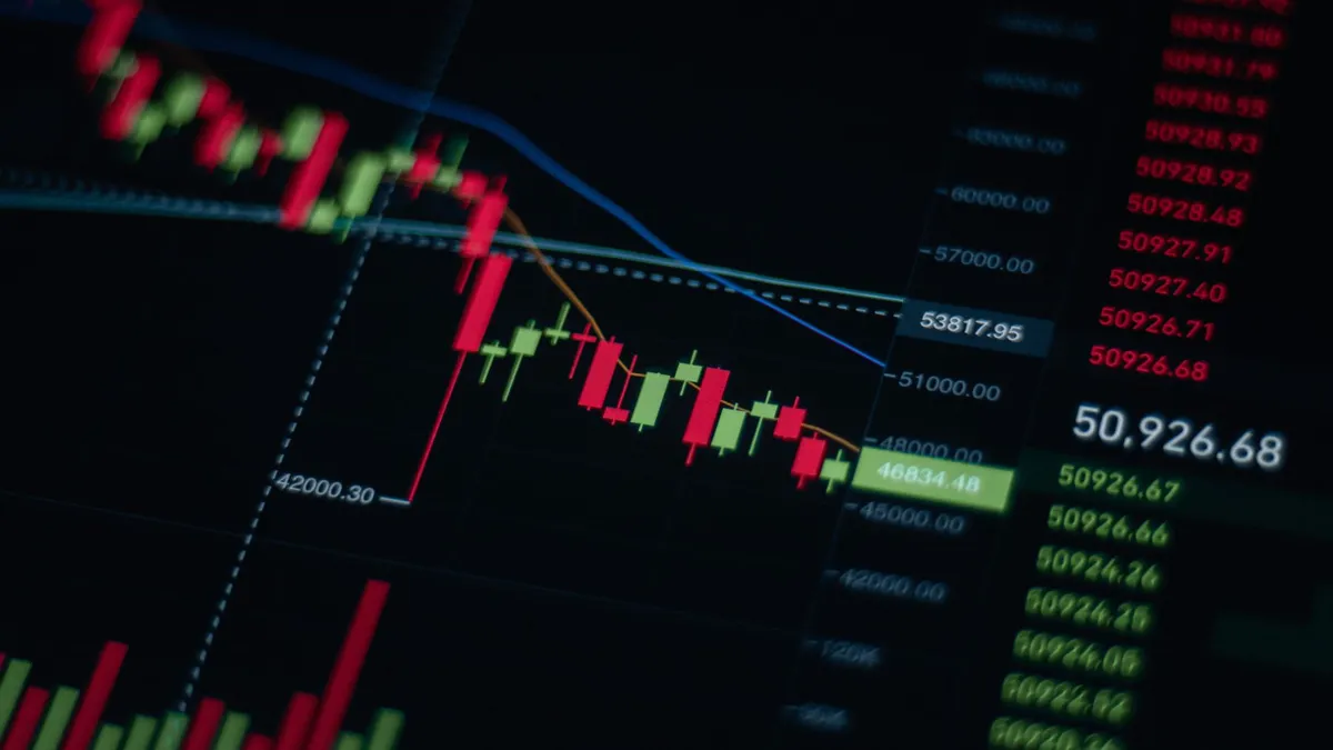 Close-up of stock market chart showing trends and data on a digital screen.