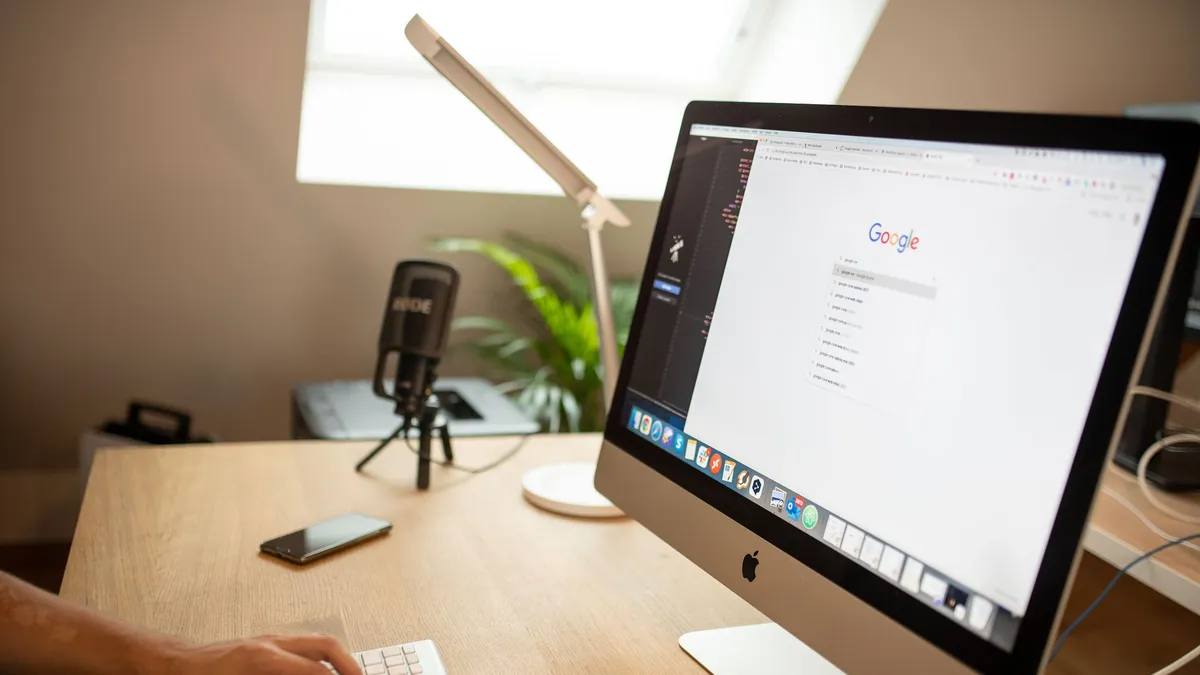 A modern workspace with an iMac displaying Google search, perfect for remote work setups.