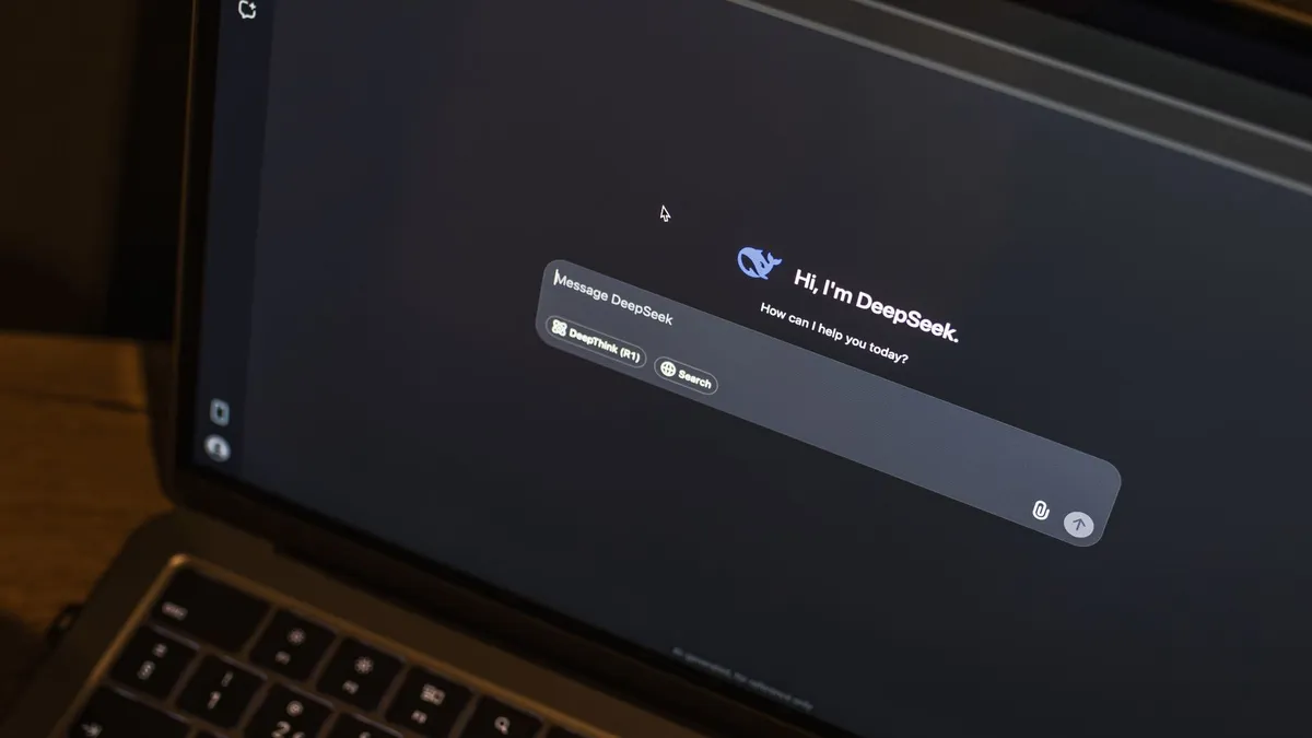 A laptop on a wooden table shows an AI chat interface, featuring the DeepSeek chatbot in action.