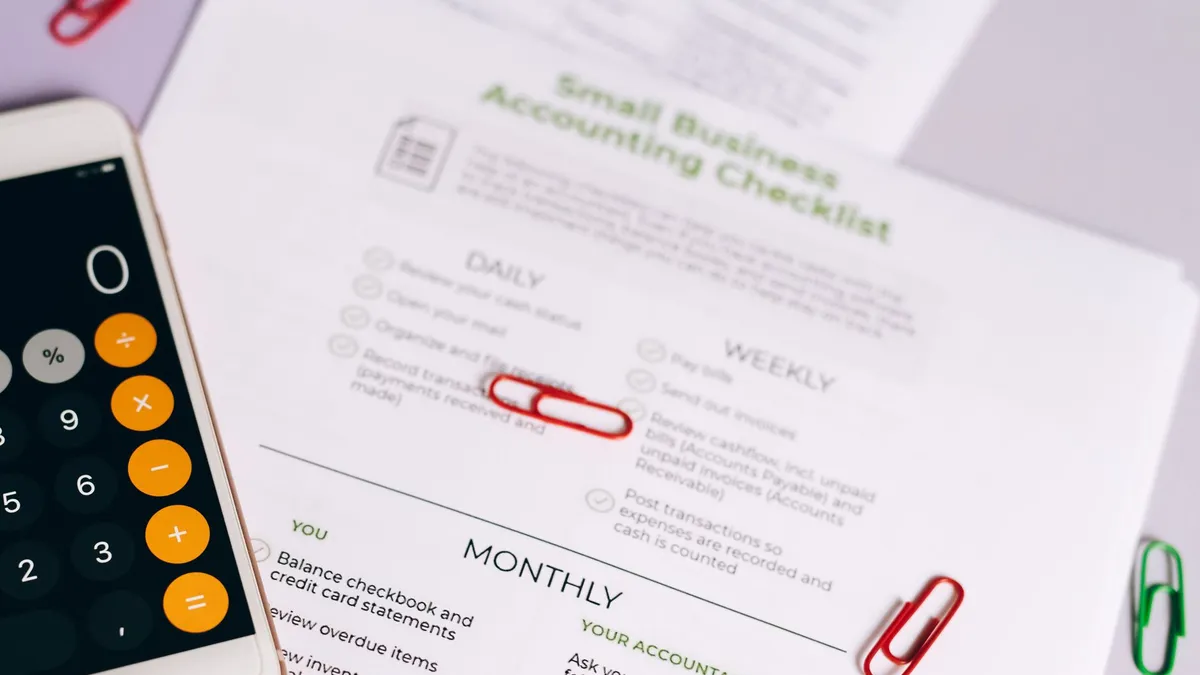Image of a checklist and calculator for managing small business accounting tasks efficiently.