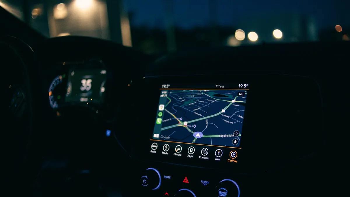 Interior view of a car featuring the GPS navigation system illuminated at night, showcasing technology and modern travel.