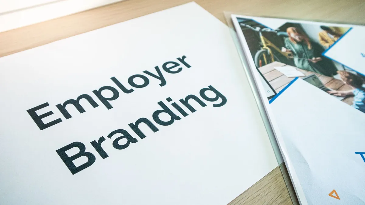 Focus on employer branding with documents on a wooden desk, ideal for business concepts.