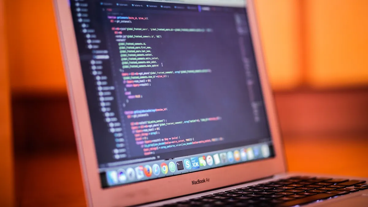 Focused shot of a laptop displaying code, suitable for tech and coding themes.