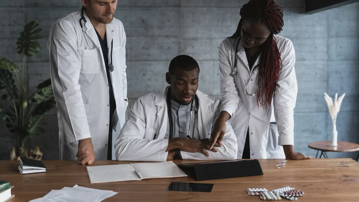 Doctors in discussion at a medical clinic, working on patient treatment plans.