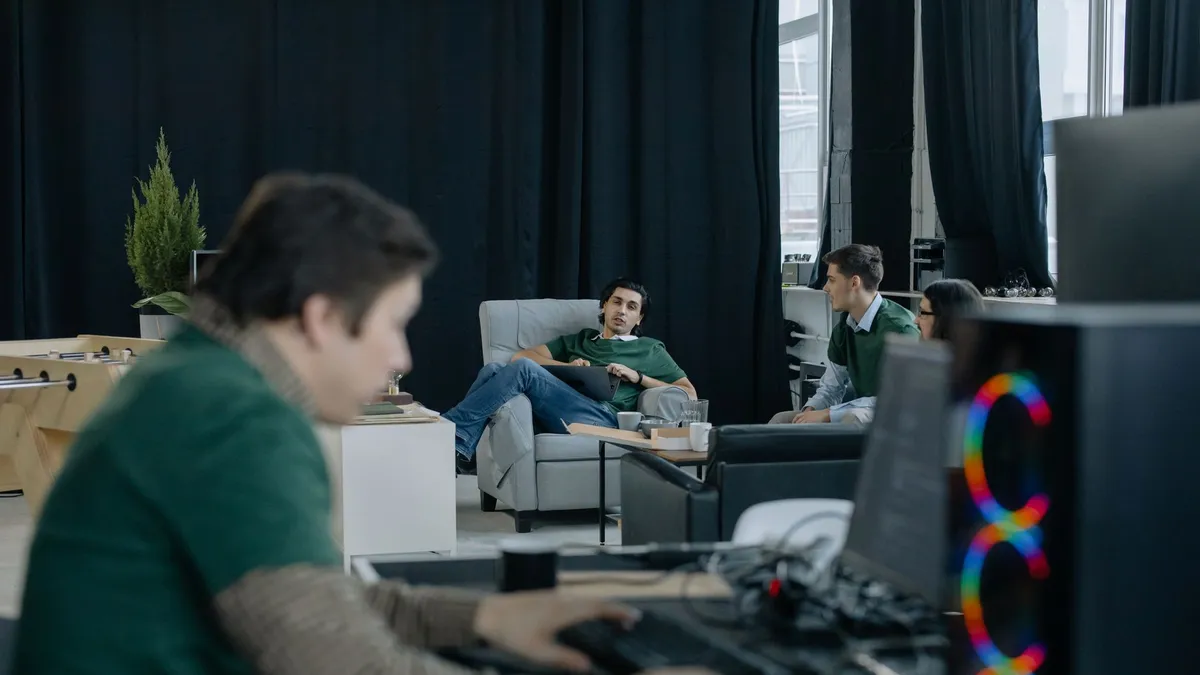 Focused group of professionals in a modern office discussing ideas and working collaboratively.