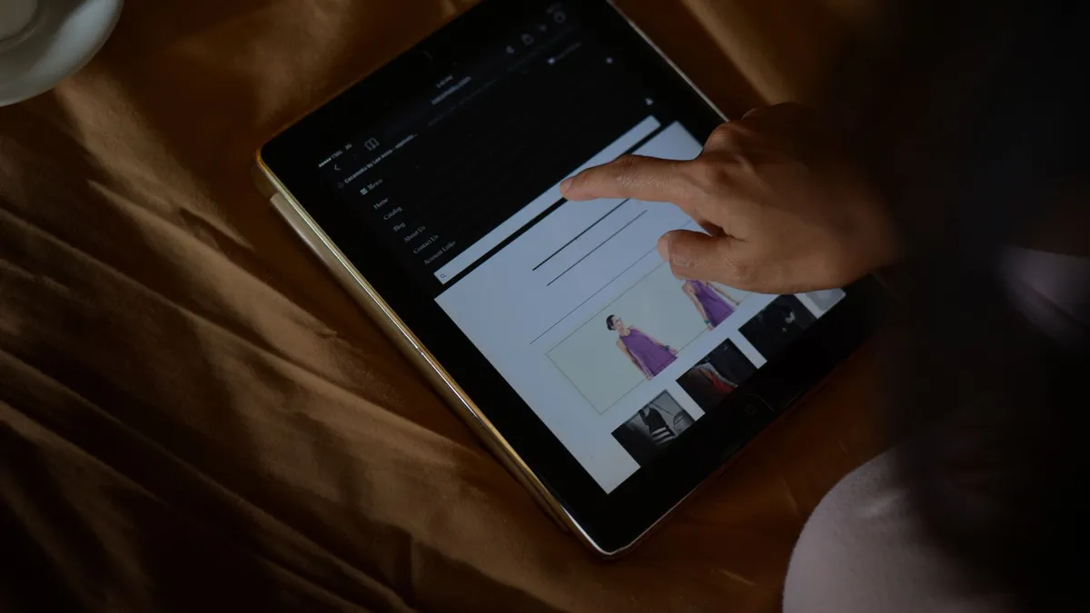 A woman browses an online shopping site on a tablet. Perfect for ecommerce and technology themes.
