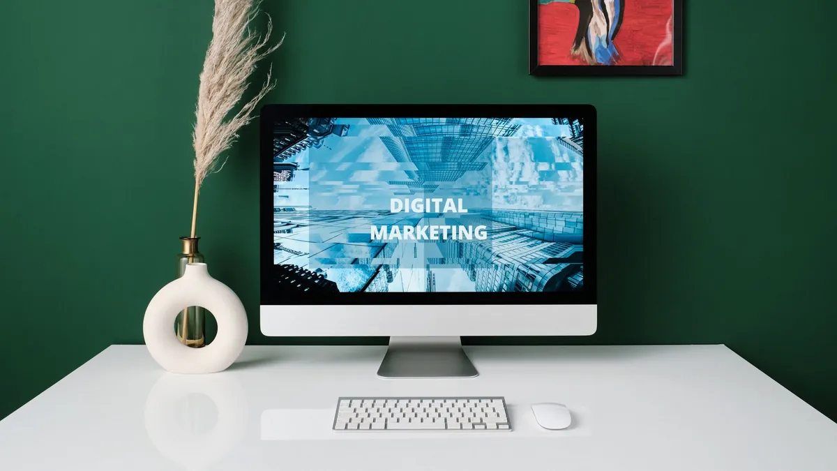 A contemporary office desk with computer screen showcasing digital marketing content.