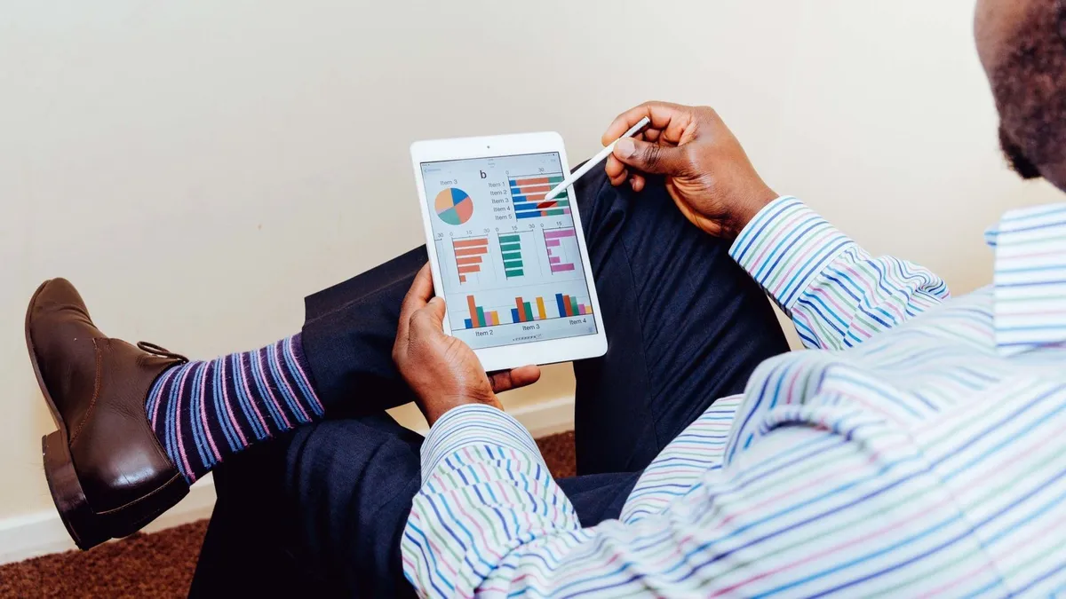 Businessman using a tablet for data analysis in a relaxed office setting.