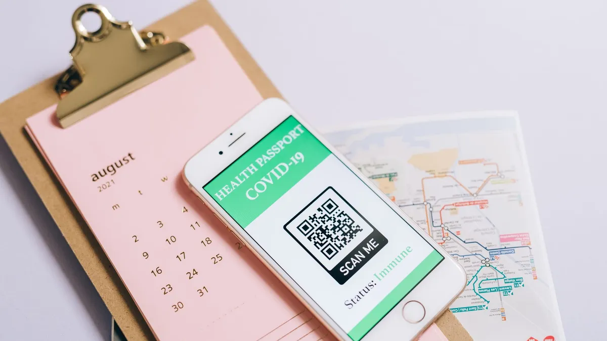Smartphone with health passport and calendar for organized travel planning.