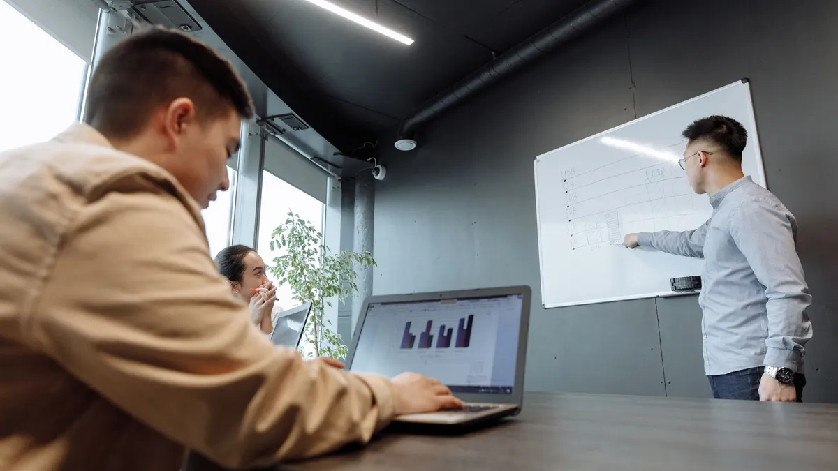 Colleagues discussing strategies in a modern conference room.