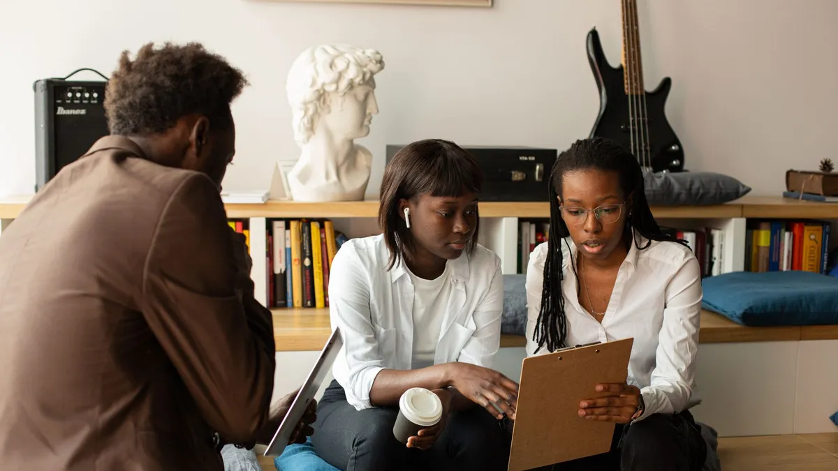 A group of professionals discussing business strategies in a creative office space.