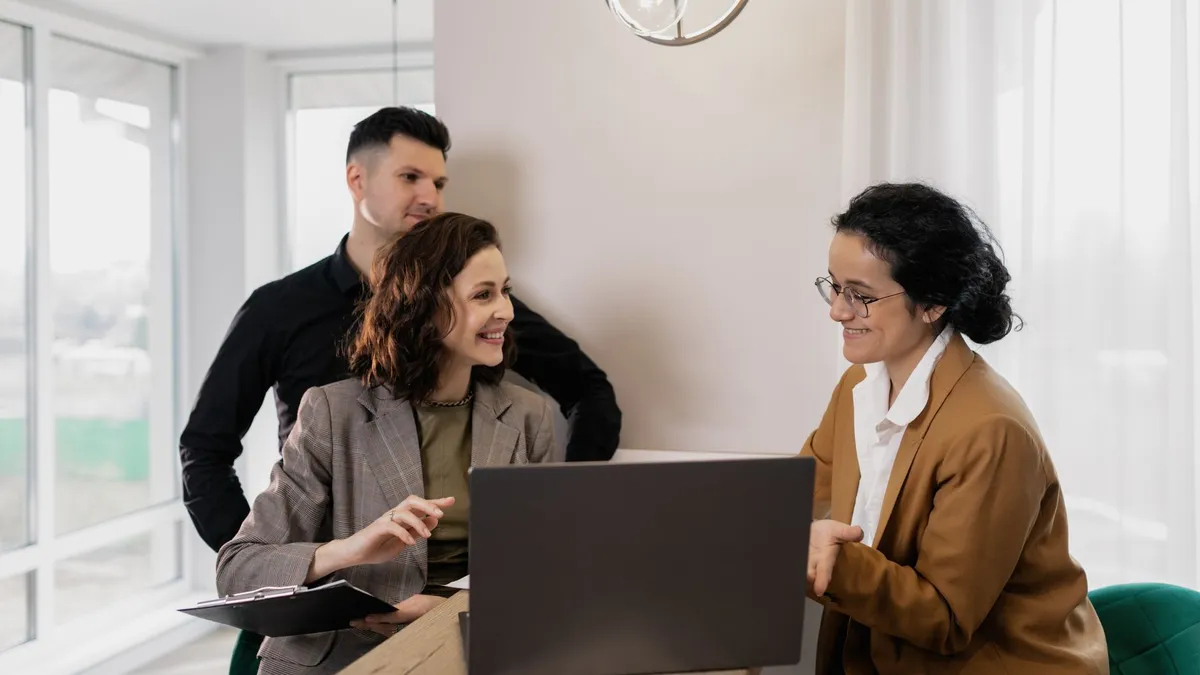 Professional real estate discussion in modern office setting with consultants and clients.