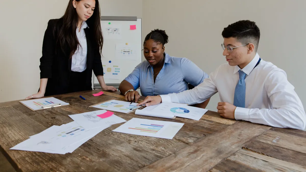 Group of diverse colleagues engaged in a productive office meeting around a table.