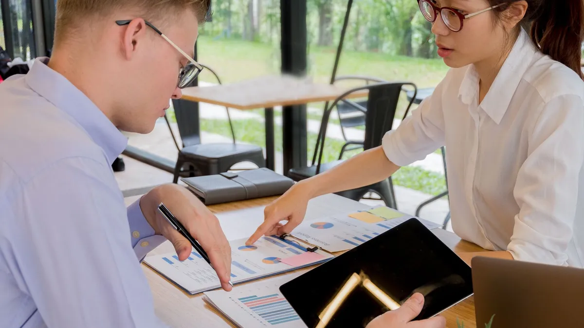 Team collaboration over financial documents in a modern office setting.