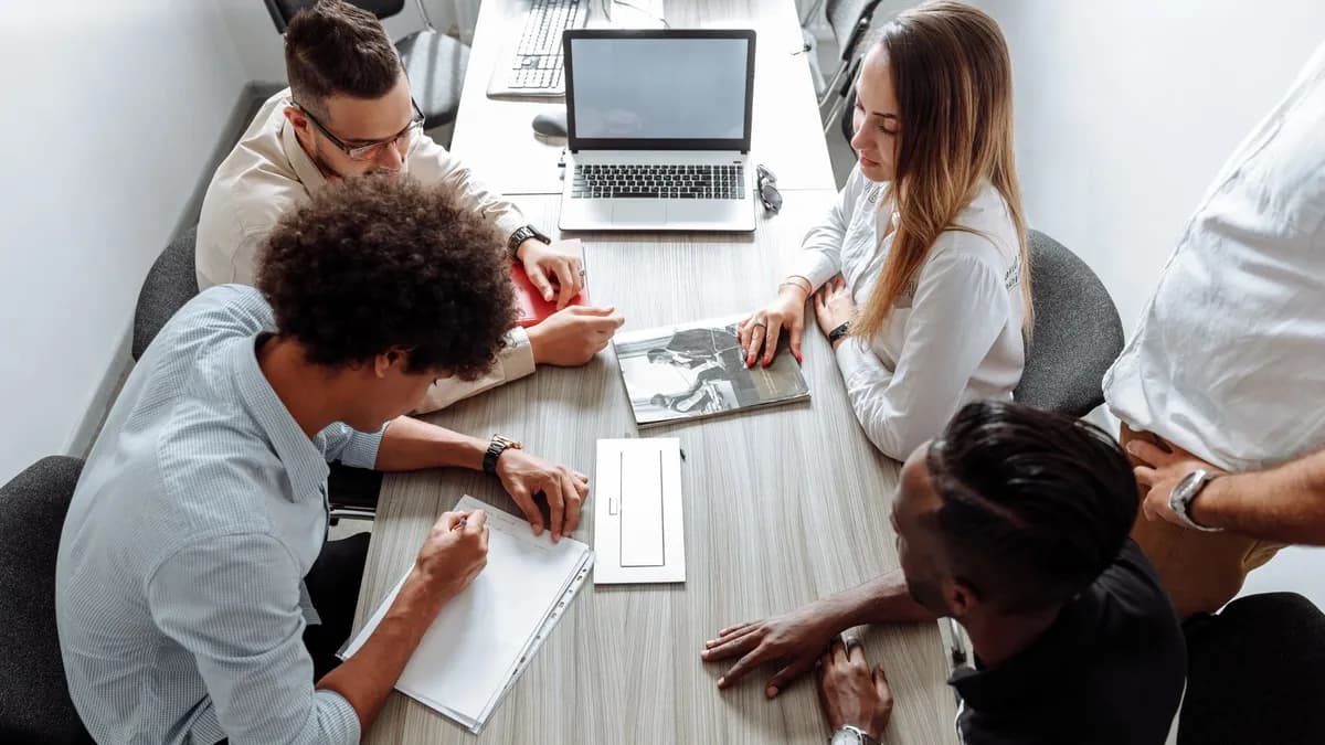 Group of diverse professionals collaborating in a modern office setting.