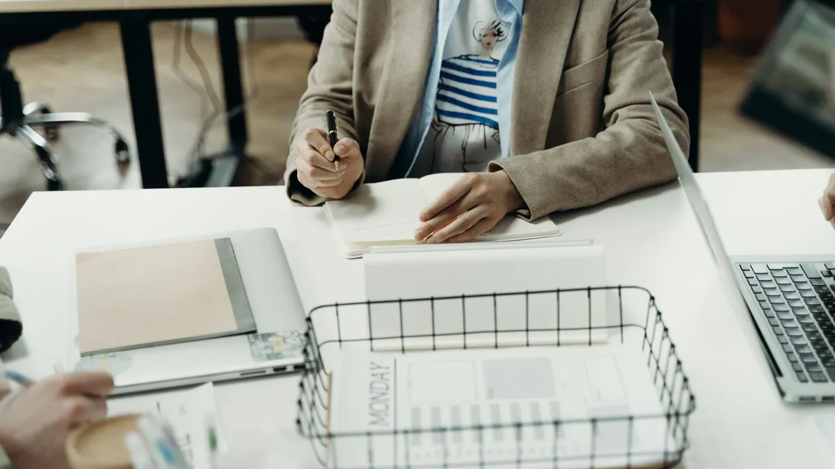 Professional office setting with a focus on planning and note-taking.