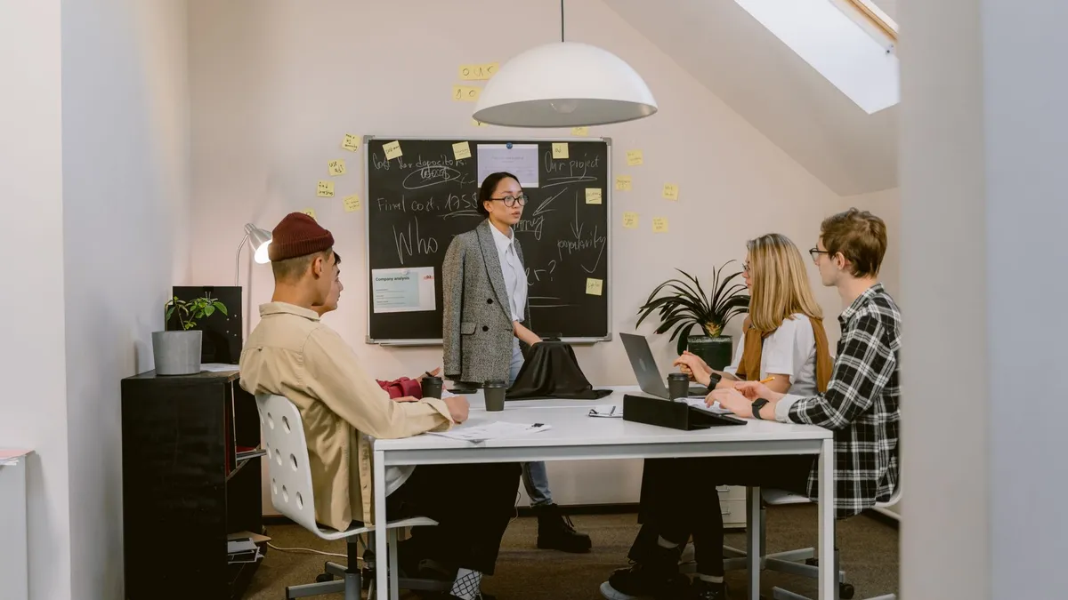 Team members engaged in a creative brainstorming session in a modern office setting.