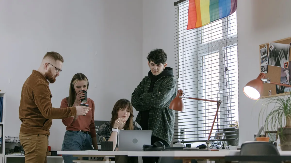 Young professionals collaborate in a creative office space, working together on a project.