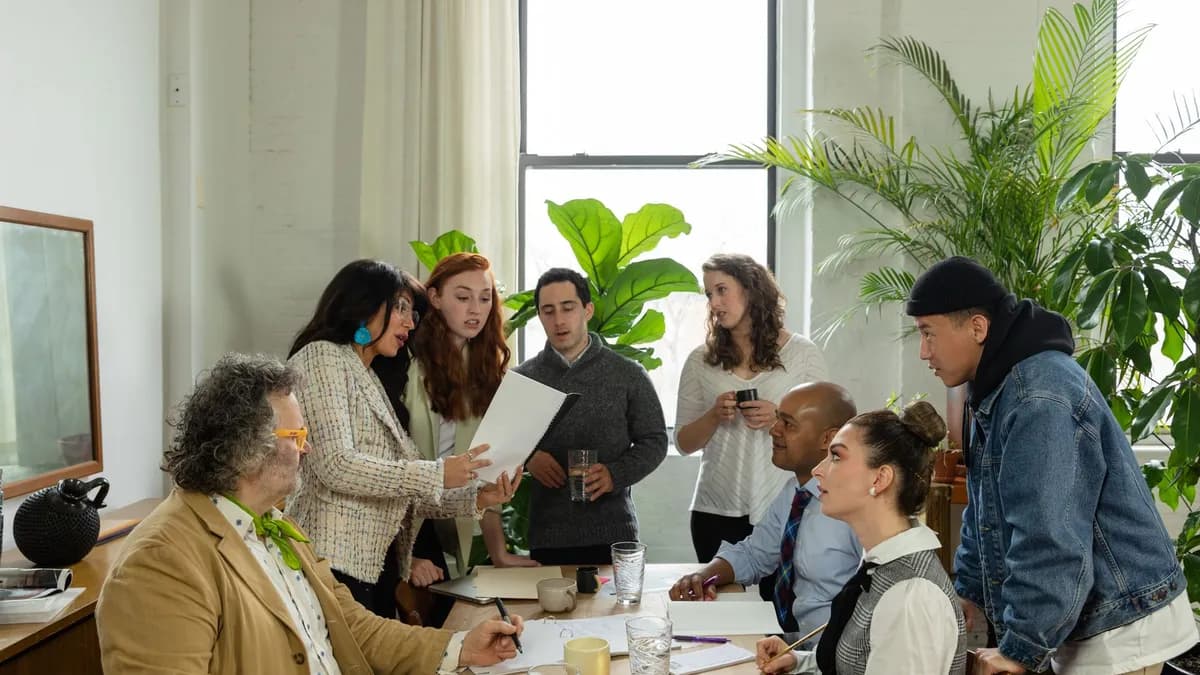 A multicultural team having a productive office meeting surrounded by greenery.