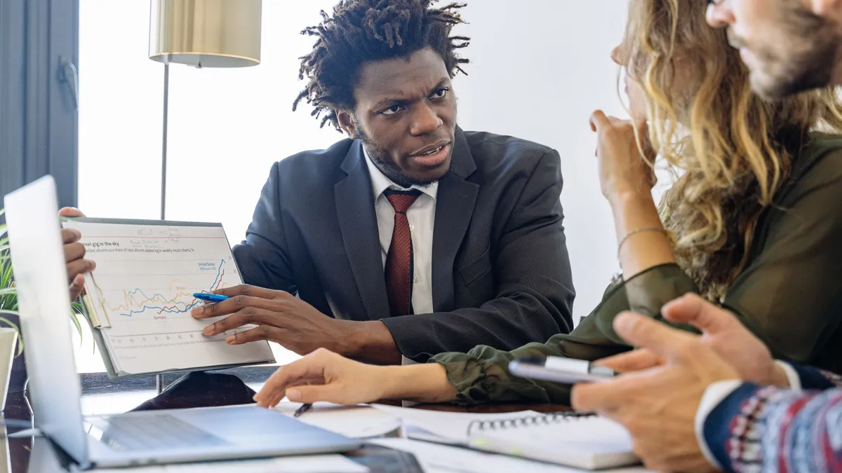 Business professionals discussing financial data during a collaborative meeting.