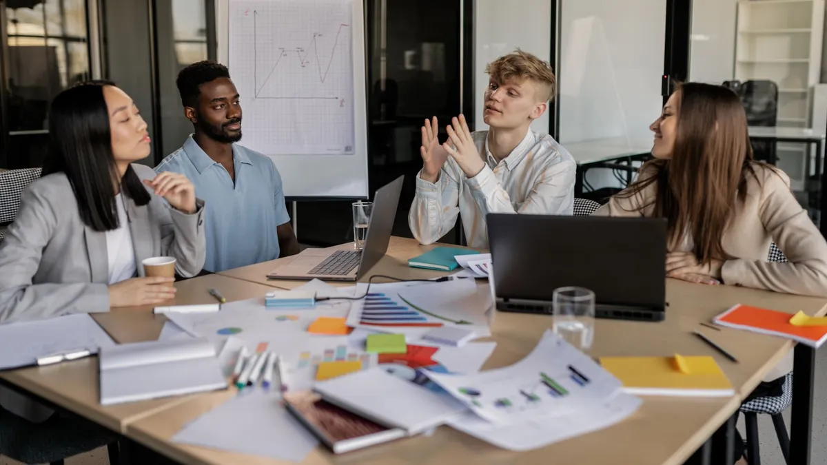 A diverse group of colleagues collaborating on a business strategy in a modern office setting.