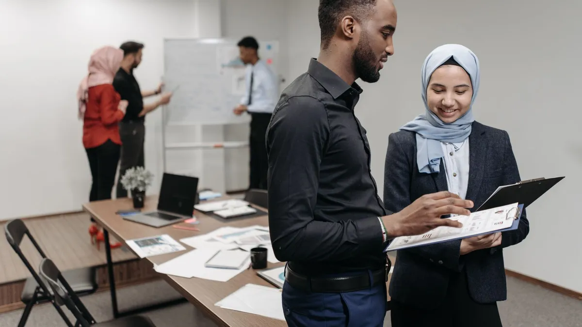 A diverse group of professionals engaged in a collaborative brainstorming session in a well-lit modern office.