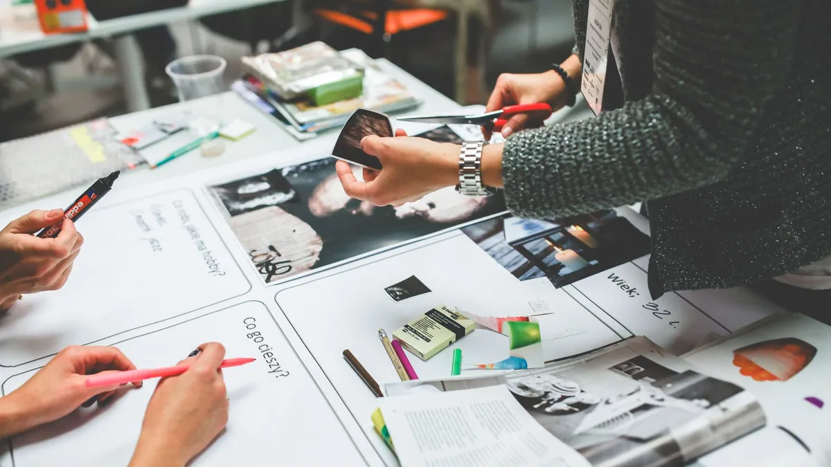 Team members brainstorming and collaborating on a design project in a modern office setting.