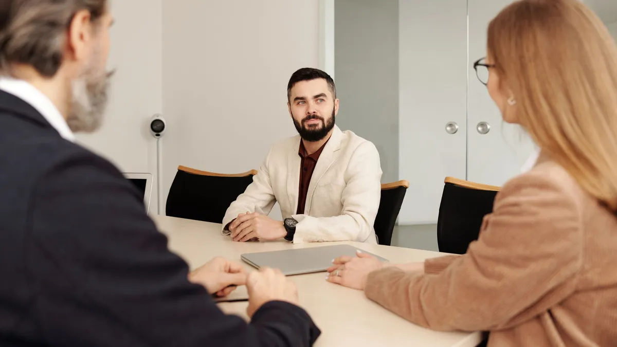 Professional business meeting with diverse team members in an office setting.