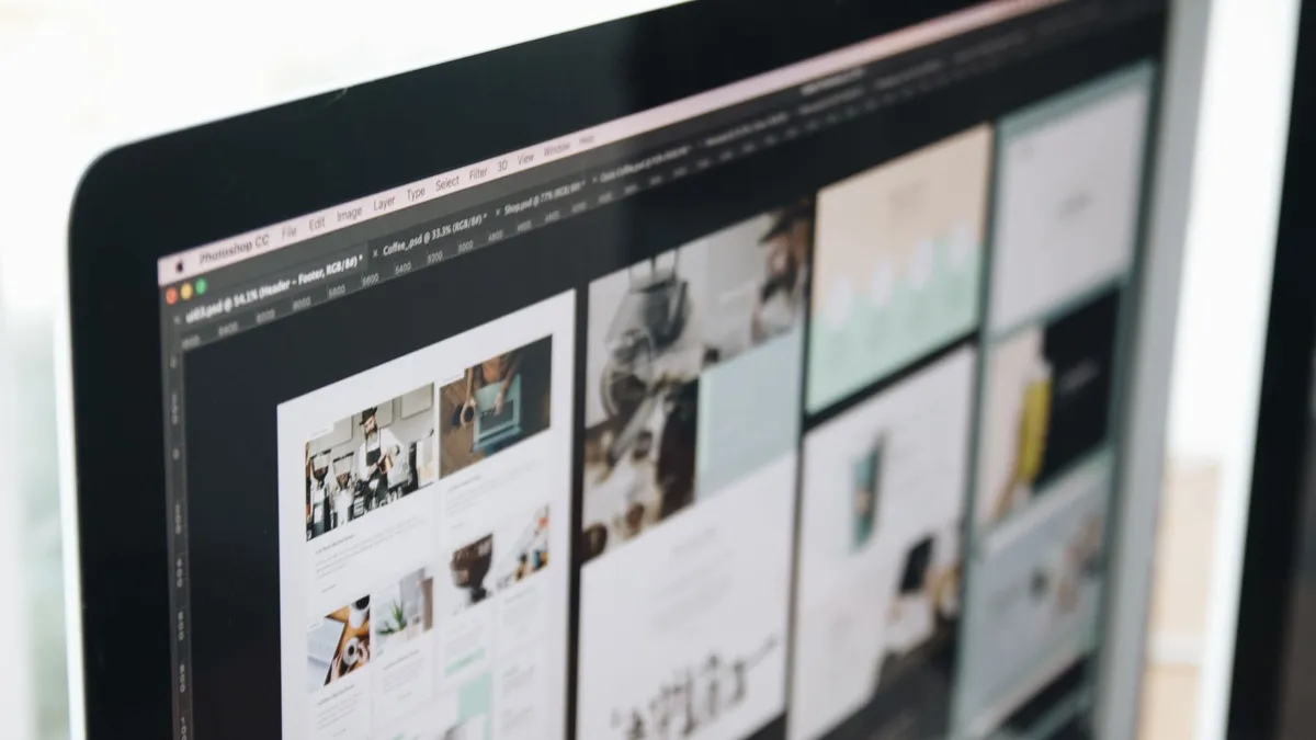 A modern computer screen displaying web design work, showcasing creative visuals in a workspace.