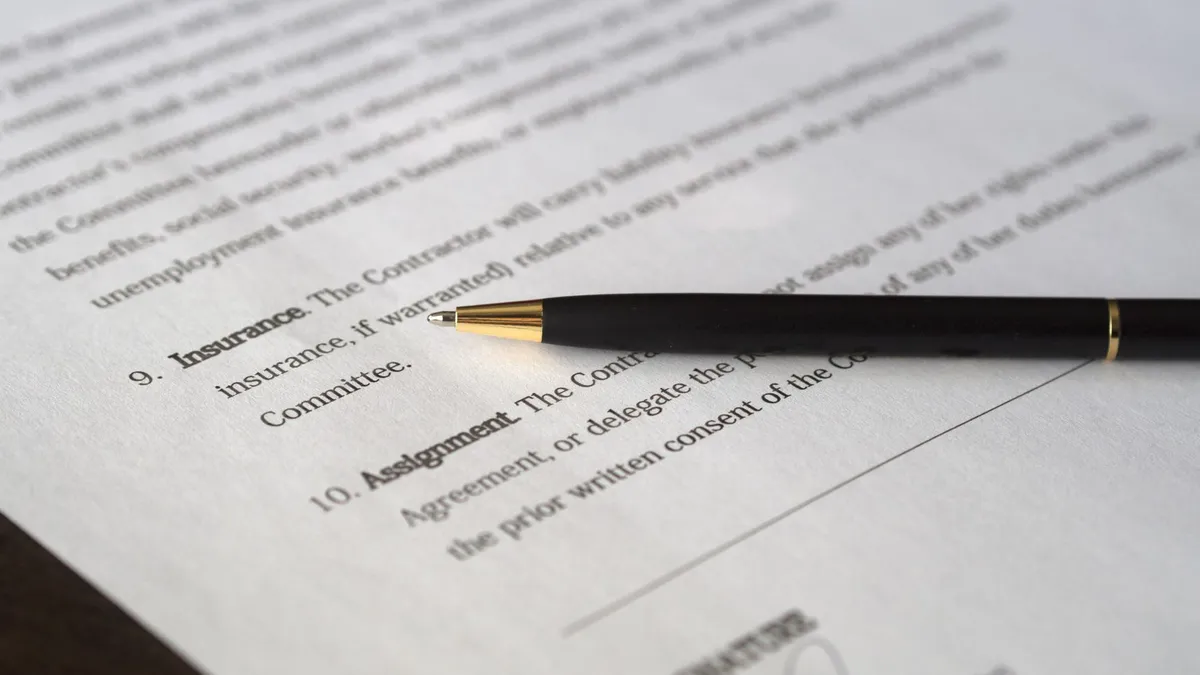 Close-up image of a business contract and pen, signed and ready for agreement.