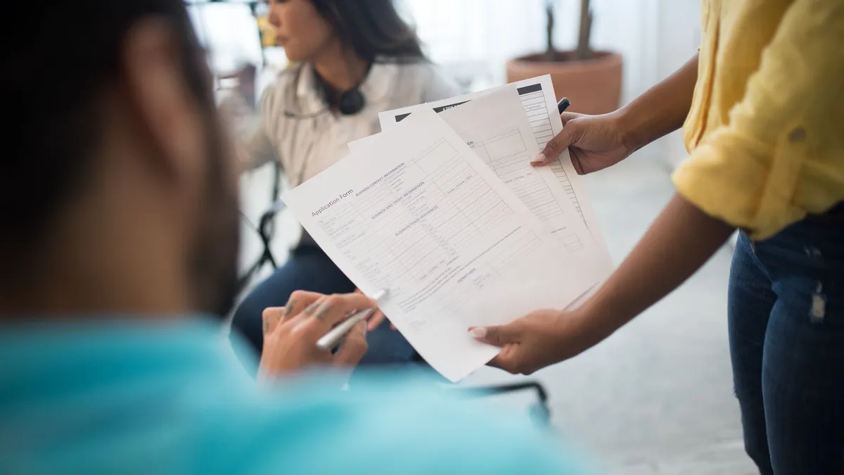 Business professionals analyzing reports during an office meeting.
