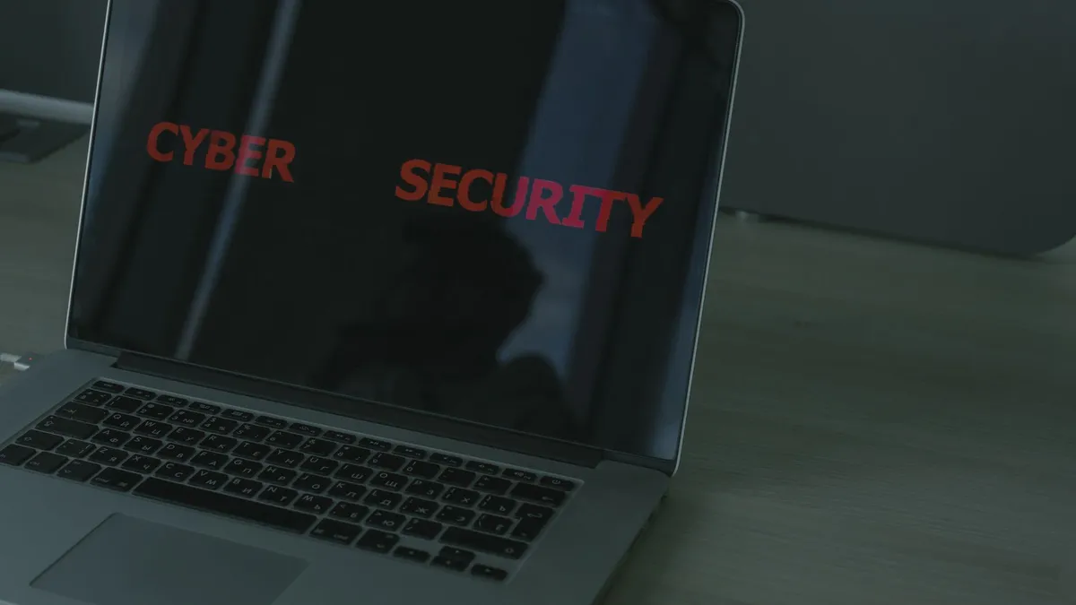 Close-up of a laptop displaying cybersecurity text, emphasizing digital security themes.