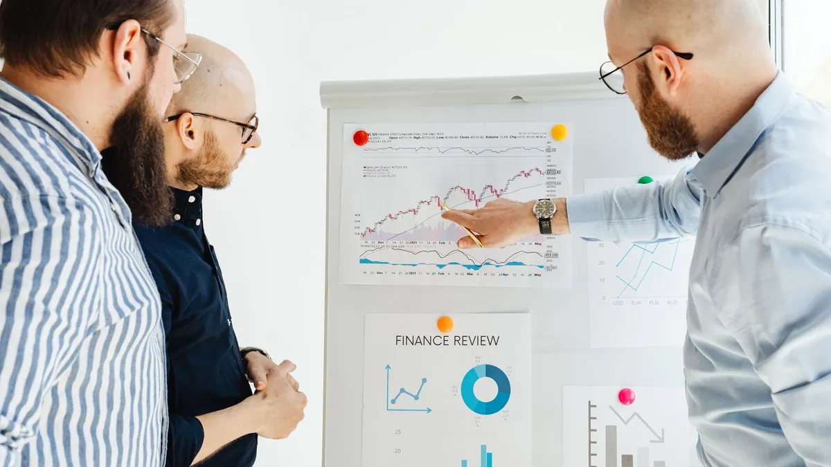 Business team reviewing financial charts during a strategy meeting indoors.