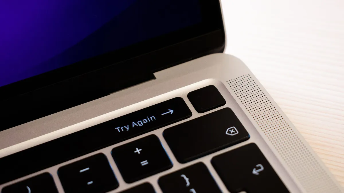 High-resolution close-up of a laptop keyboard featuring a 'Try Again' button.