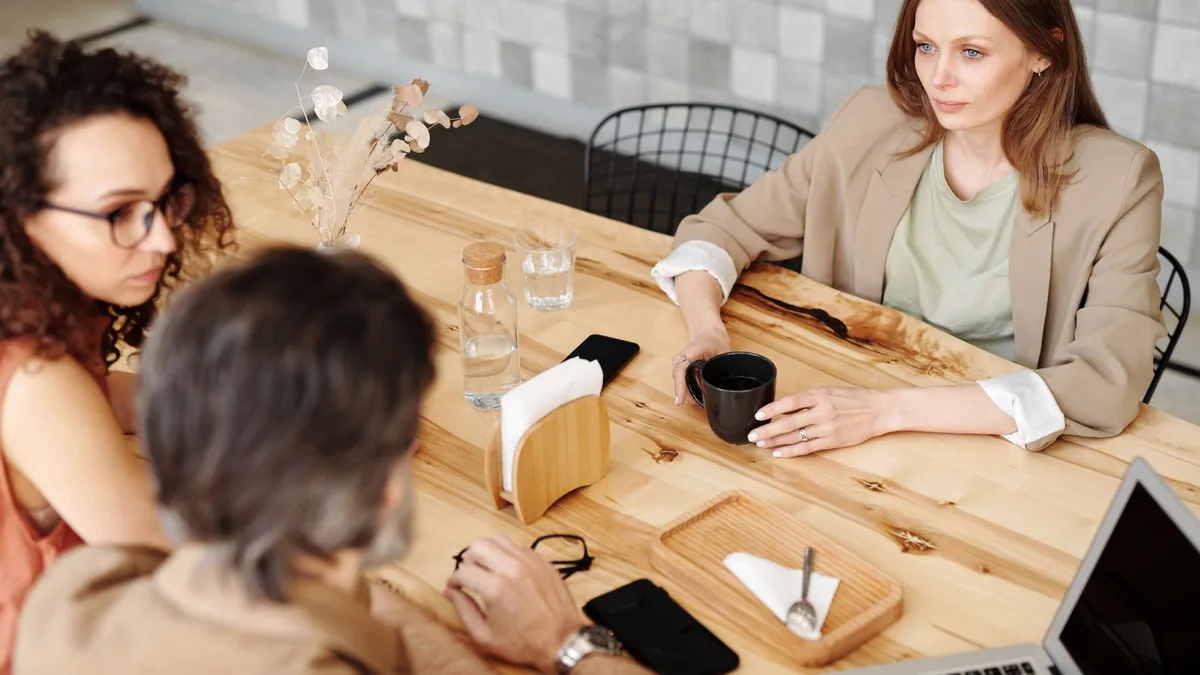 Colleagues having a team discussion at a contemporary café.